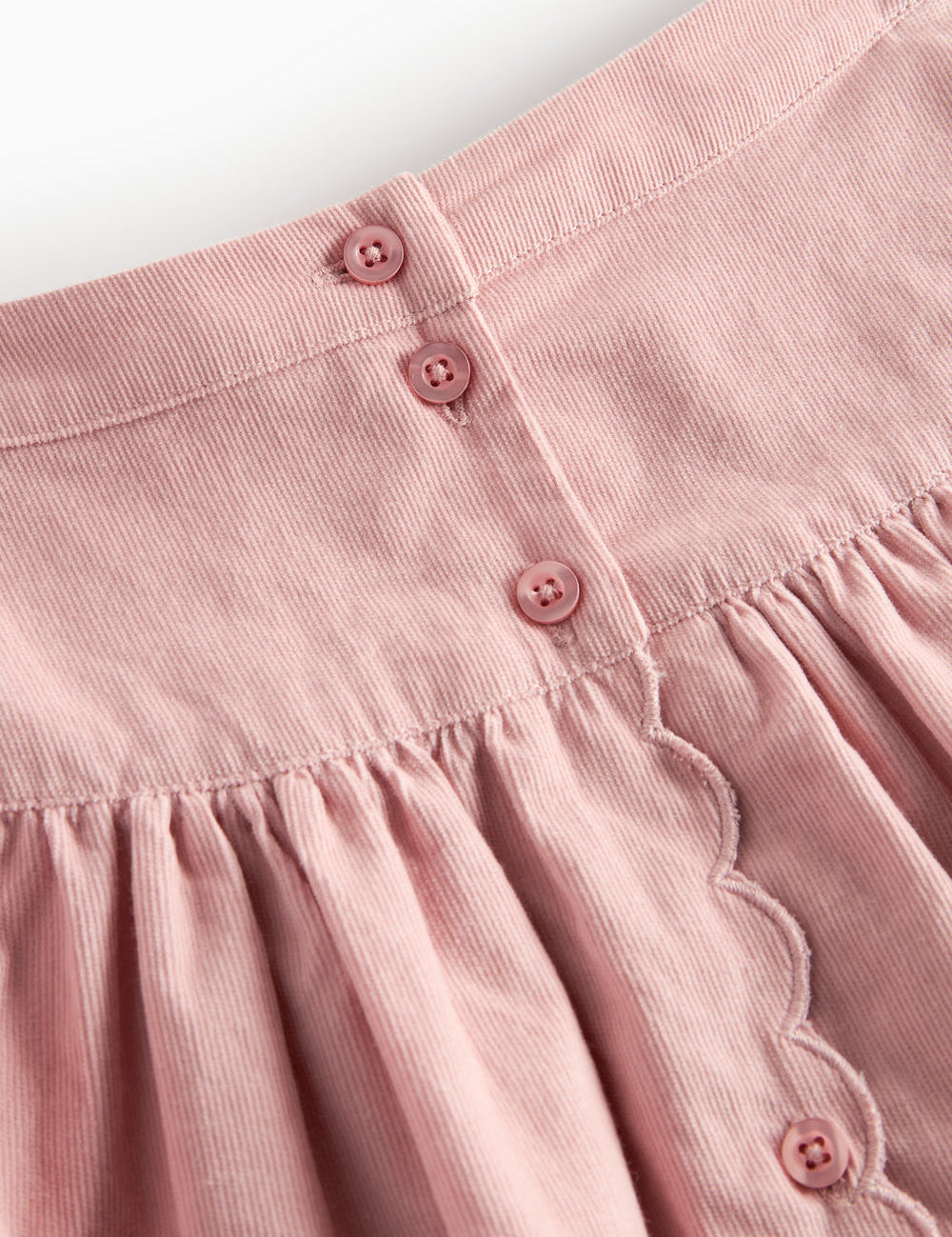 Pink skirt in baby velvet with buttons and wave edge for children