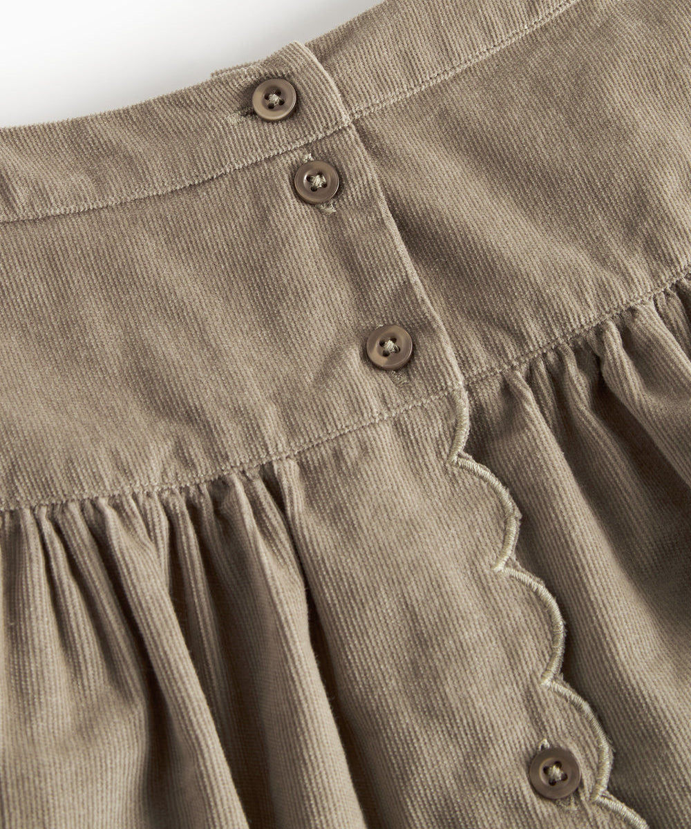Beige nederdel i babyfløjl med knapper og bølgekant til børn