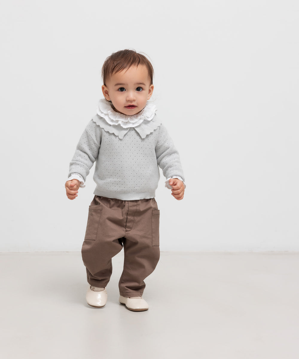 Børn iført khaki bukser og grå strikbluse