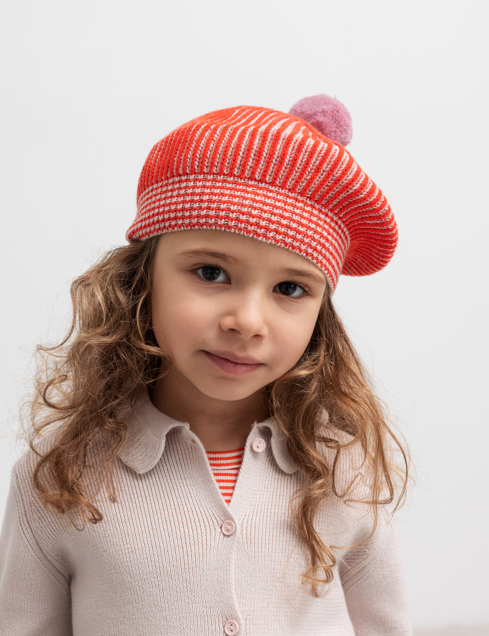 Children wearing beige cardigan with collar, styled with red knitted hat
