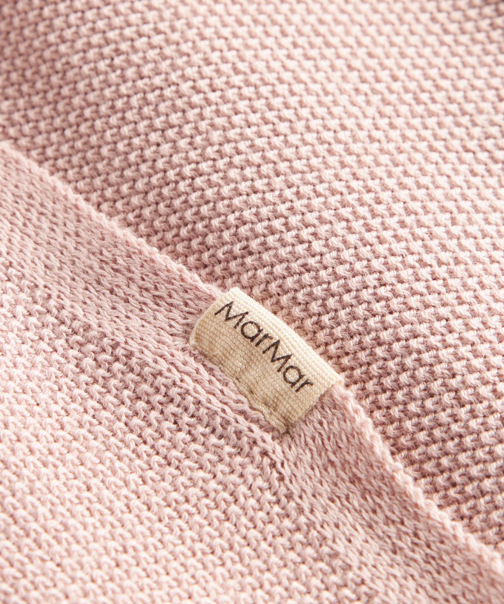 Lyserød strikket babytæppe