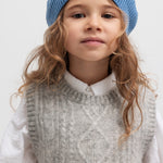 Børn med blå hue, grå strikket vest og hvid bluse