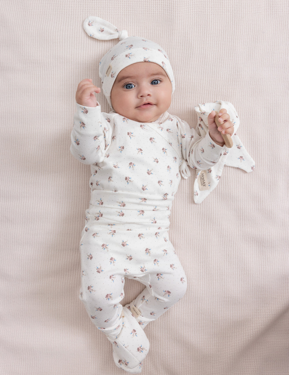 Baby in baby clothes with floral pattern