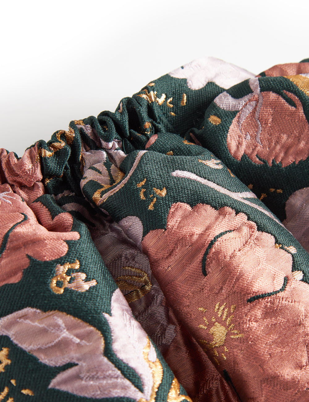 Kort mørkegrøn nederdel med store blomster og sløjfedetalje til børn