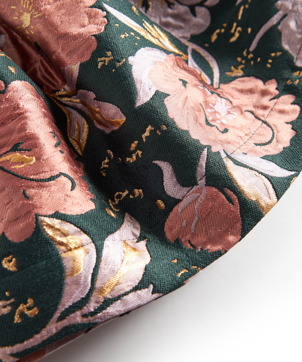 Kort mørkegrøn nederdel med store blomster og sløjfedetalje til børn