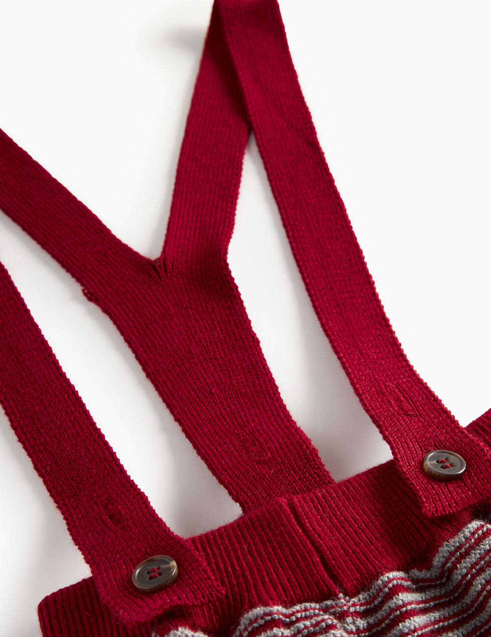 Knitted trousers with red and grey stripes and suspenders for baby