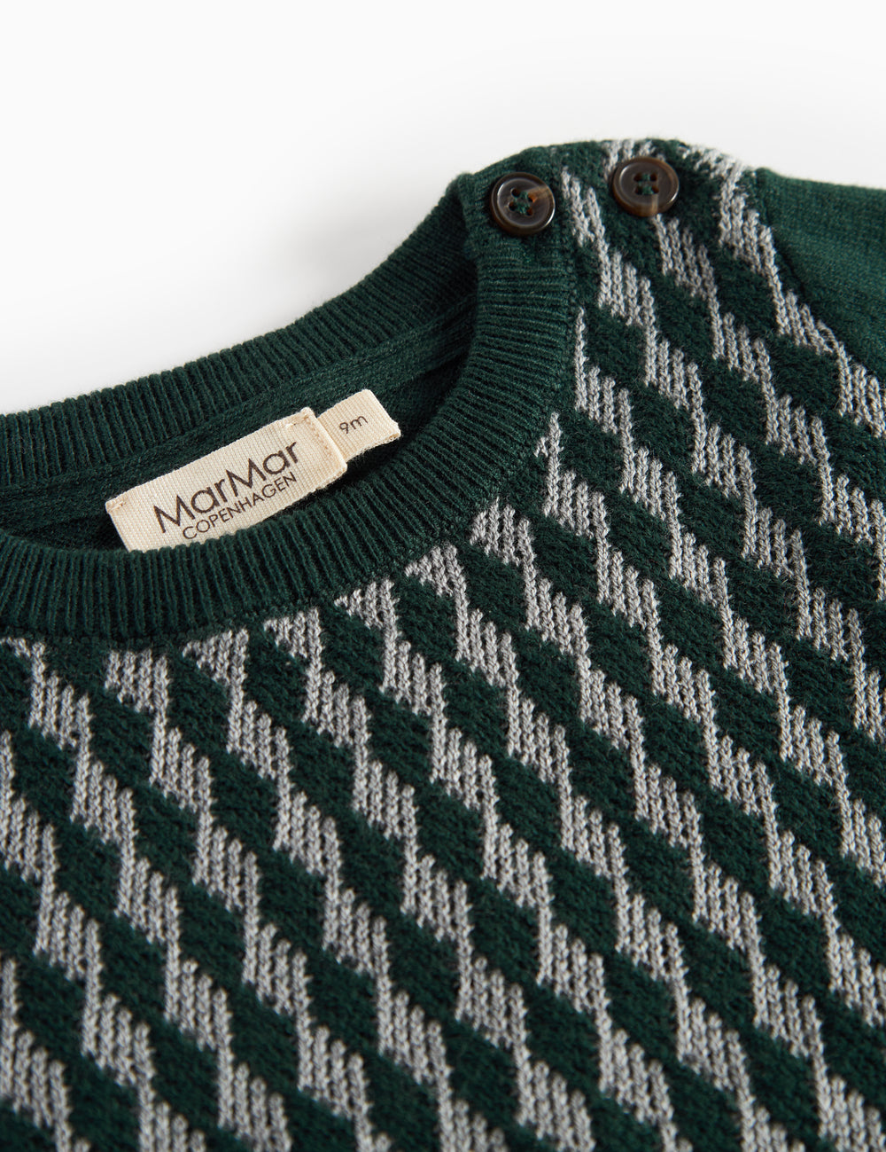 Knitted baby blouse with checkered pattern in dark green