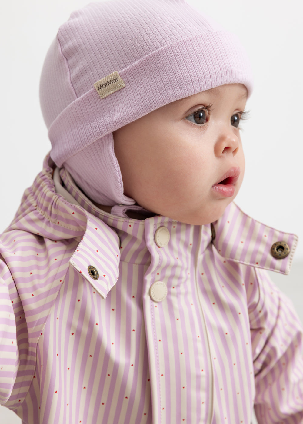 Wearing a yellow and striped raincoat with a hat and matching hat.