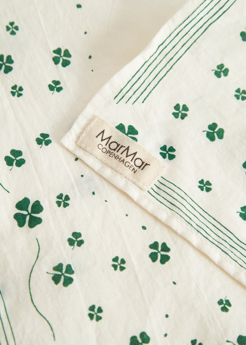 Beige towel with green clover print