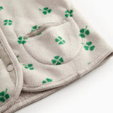 Beige vest with green clover print and buttons for baby and children