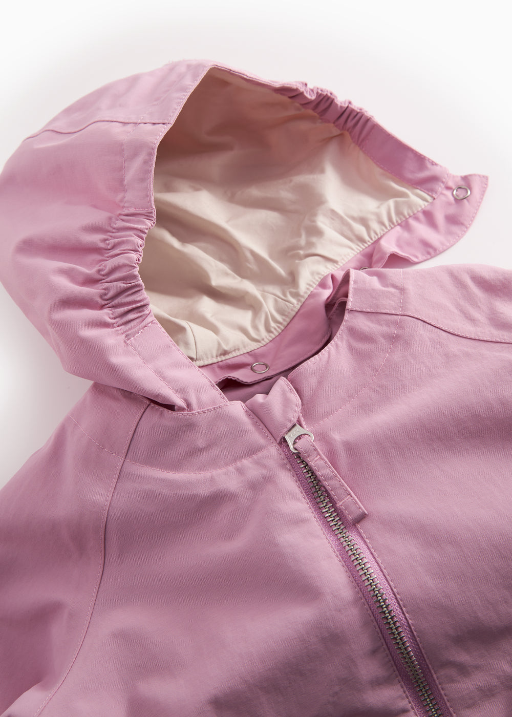 Details of a yellow transition jacket with water beads on the fabric.