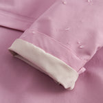 Lyserød overgangsjakke med hætte, lommer og knapper