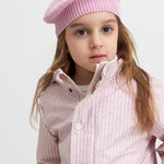 Child wearing a yellow striped raincoat and matching hat.