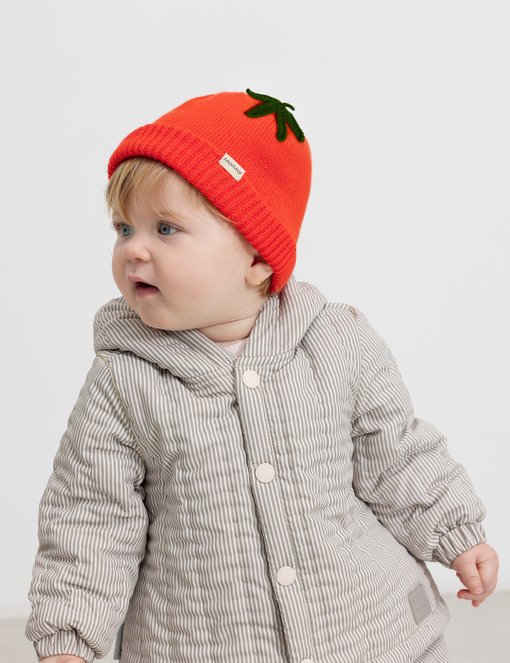 Red striped hat worn by baby