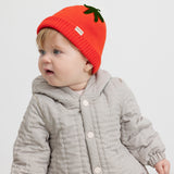 Baby brown thermal jacket with buttons and a red knitted hat