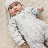 Baby I thermally insulated with a matching knitted hat.