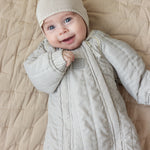 Baby I thermally insulated with a matching knitted hat.