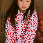 Children in red thermal jackets with leopard print.