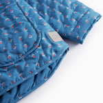 Blue thermal jacket for children with a floral pattern and pockets.
