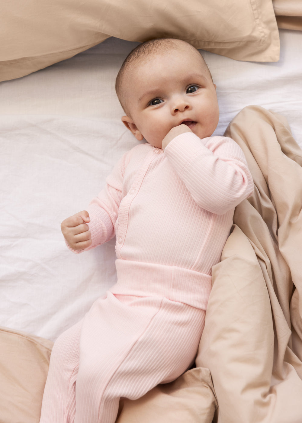 Baby wearing red baby pants with feet