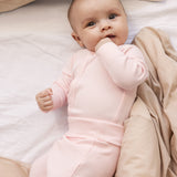 Baby wearing red baby pants with feet