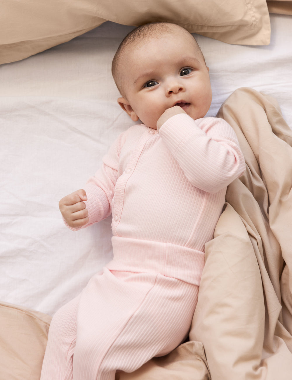 Baby wearing long-sleeved bright red bodystocking for newborns