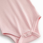 Red long-sleeved baby bodystocking with snap closure.