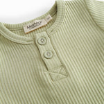 Red short-sleeved baby bodystocking with garter snap closure.