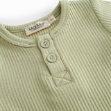 Red short-sleeved baby bodystocking with garter snap closure.