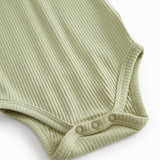 Red short-sleeved baby bodystocking with garter snap closure.