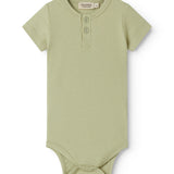 Red short-sleeved baby bodystocking with garter snap closure.