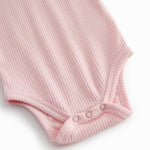 Red short-sleeved baby bodystocking with garter snap closure.