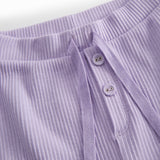 Pink baby bloomers with button closure and a decorative band at the waist.