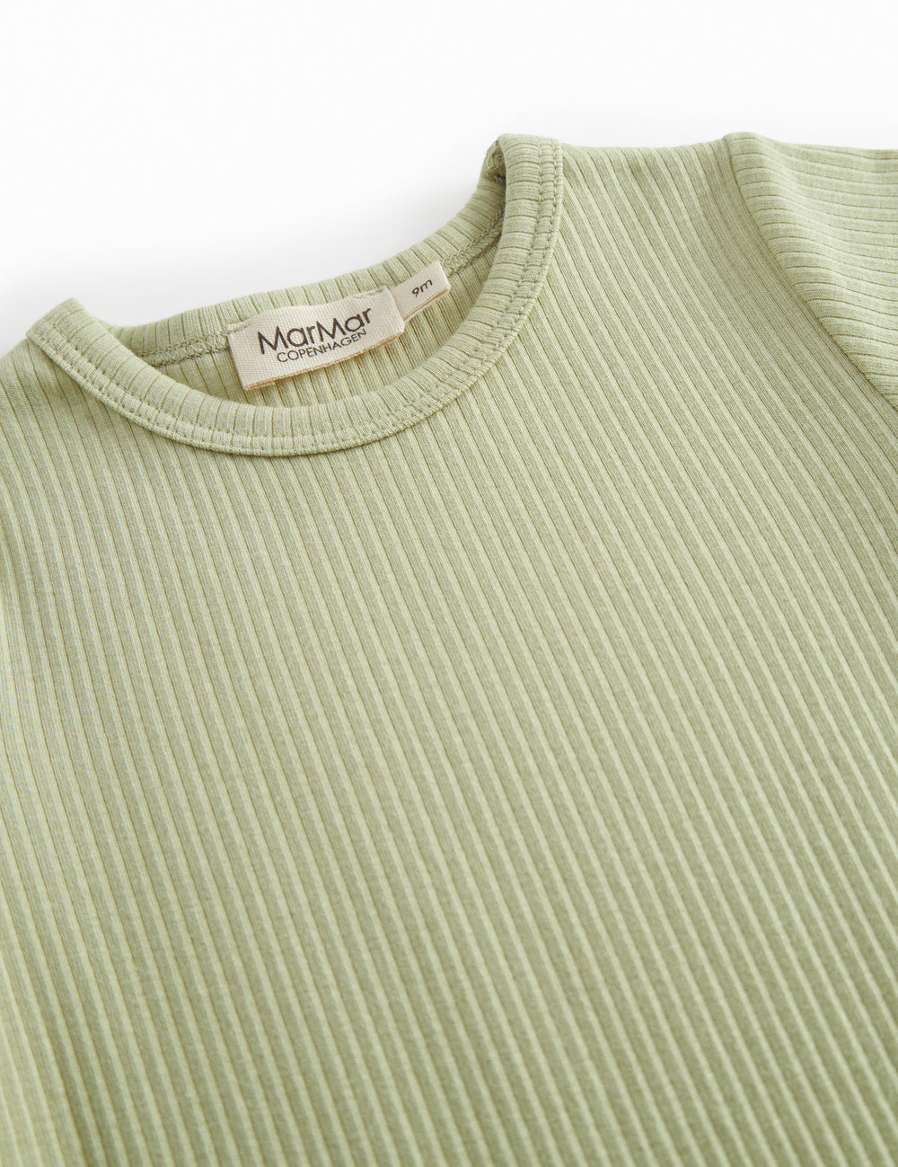 Short-sleeved baby modal romper with short legs in a light green shade.