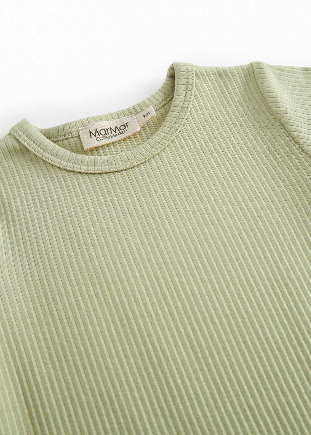 Short-sleeved baby modal romper with short legs in a light green shade.