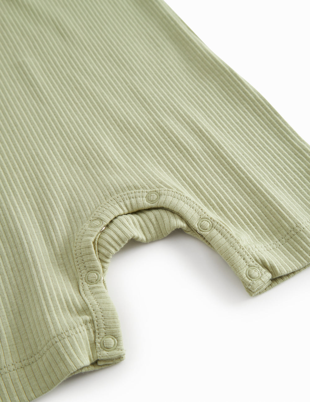 Short-sleeved baby modal romper with short legs in a light green shade.
