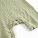 Short-sleeved baby modal romper with short legs in a light green shade.