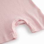 Short-sleeved baby modal romper with short legs in a light red shade.