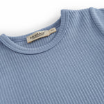 Short-sleeved baby modal romper with short legs in a light blue shade.