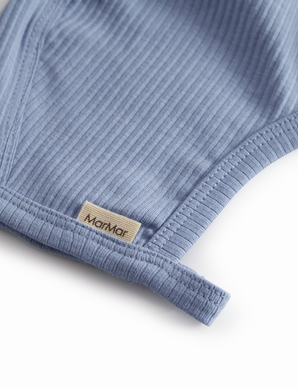 Light blue baby modal hue with button closure