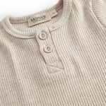 Short-sleeved baby modal bodystocking with snap closure.