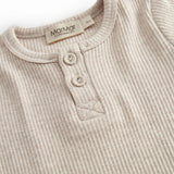 Short-sleeved baby modal bodystocking with snap closure.