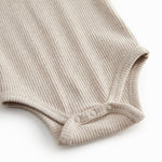 Beige ribbed baby bodystocking without sleeves