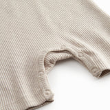 Short-sleeved beige baby modal romper with short legs