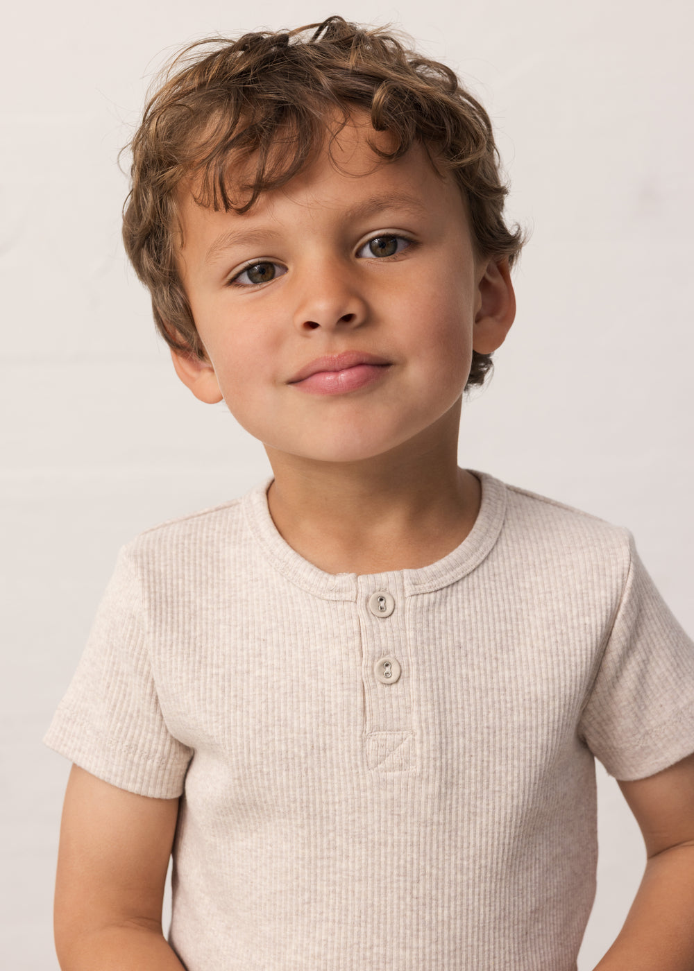 children wearing a beige ribbed t-shirt with buttons
