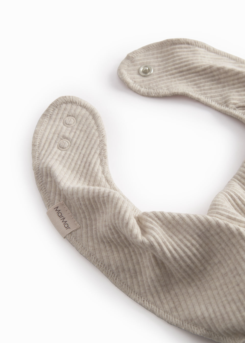 Beige baby salves that close with a button.