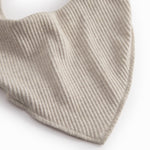 Beige baby salves that close with a button.