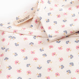 Langærmet bodystocking for a newborn baby with snap closure and flowers.