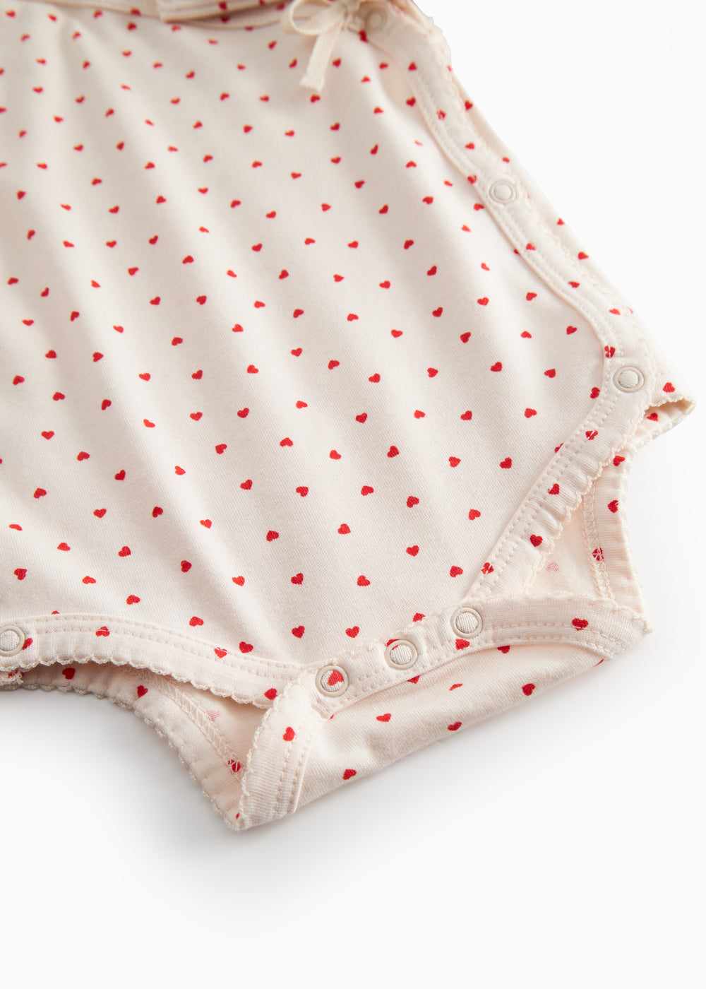 Langärmet bodystocking for newborns with snap closure and heart print