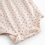 Langärmet bodystocking for newborns with snap closure and heart print